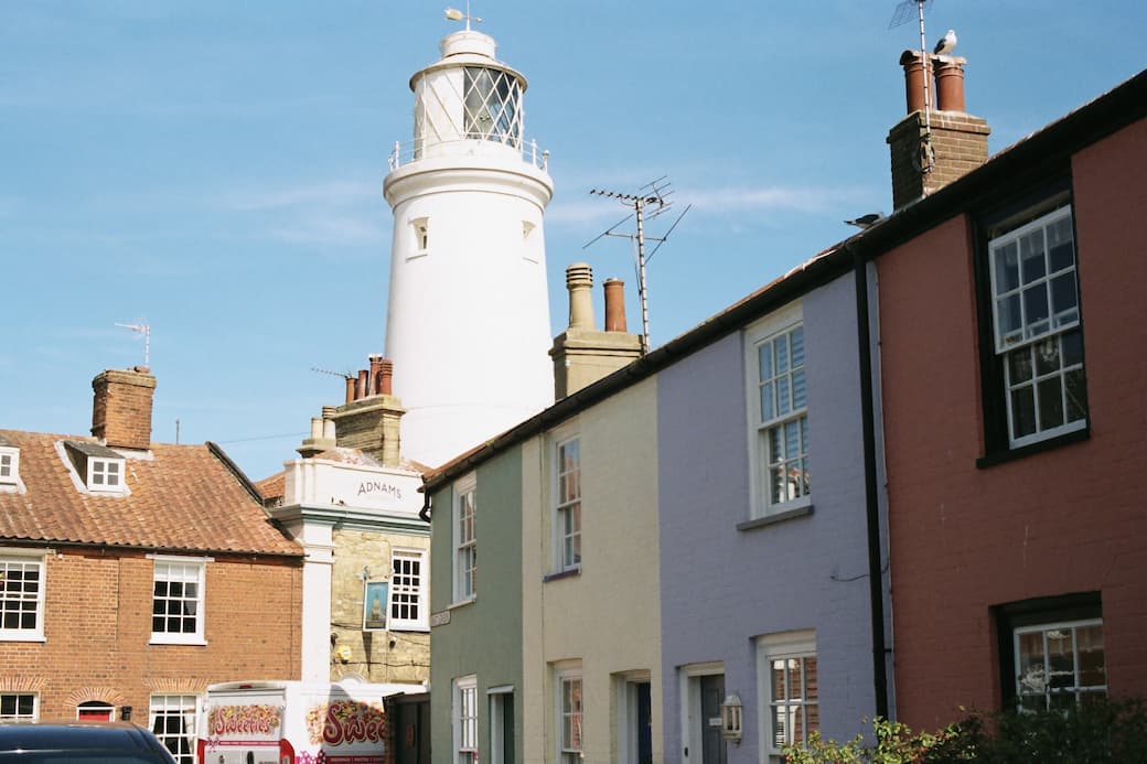 White lighthouse with paste-coloured houses in Southwold_The best UK holiday destinations for families