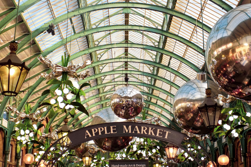 Large Christmas decorations and glitter balls suspended in Apple Market in Covent Garden. Best things to do in London on a rainy day.