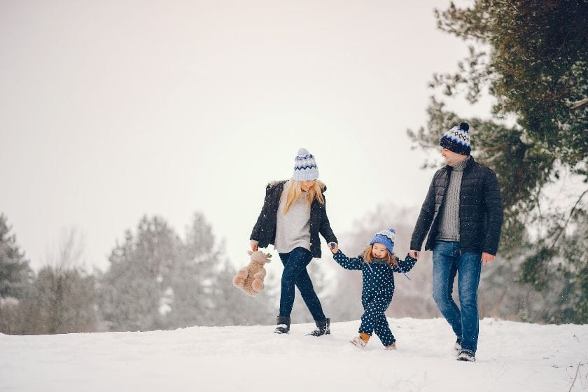 A family enjoying a winter walk. The dates for Spring break vary across Canada