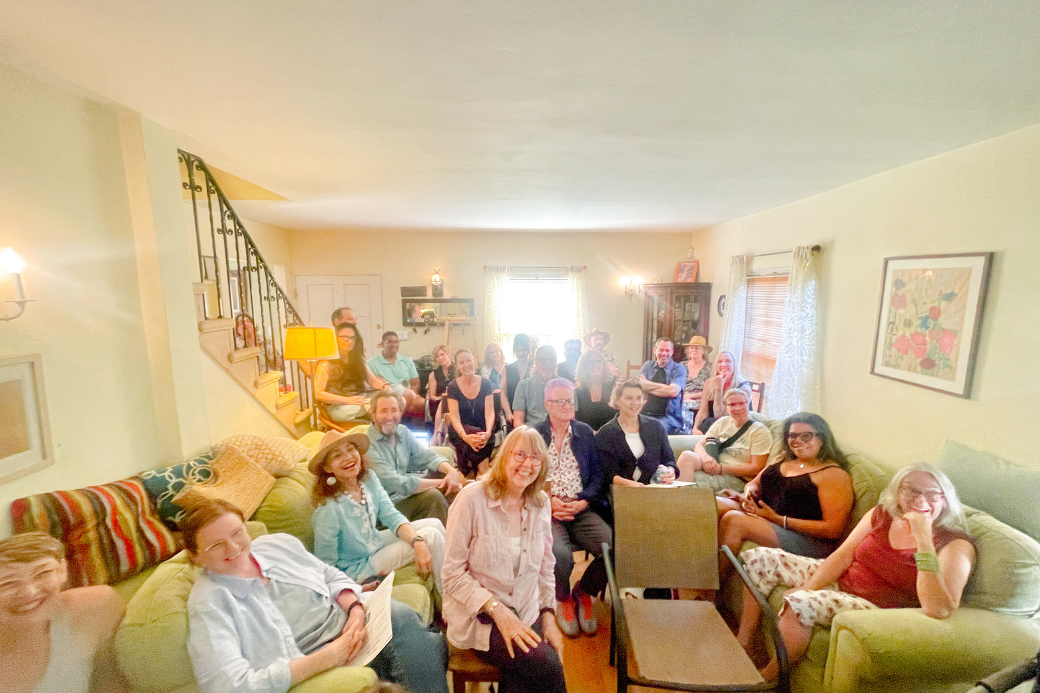 Living room with lots of people for a HomeExchange Open Homes event.