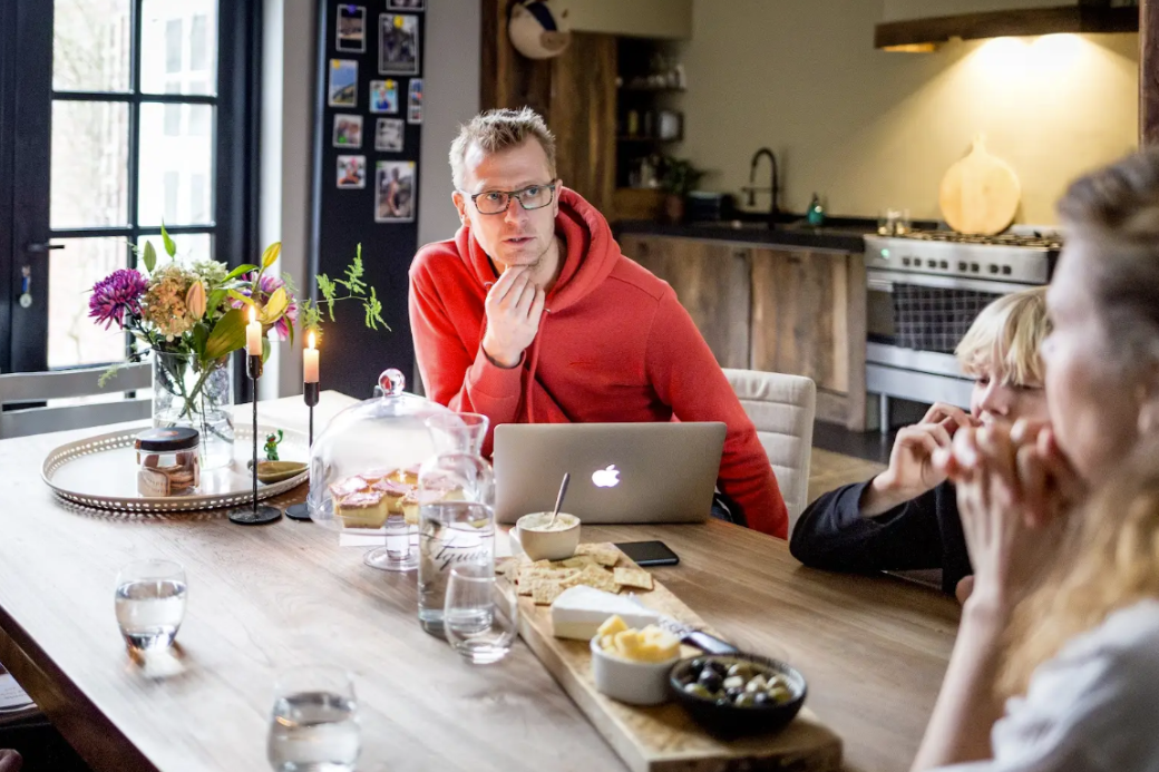 Man in red hoodie hosting guests for Open Homes